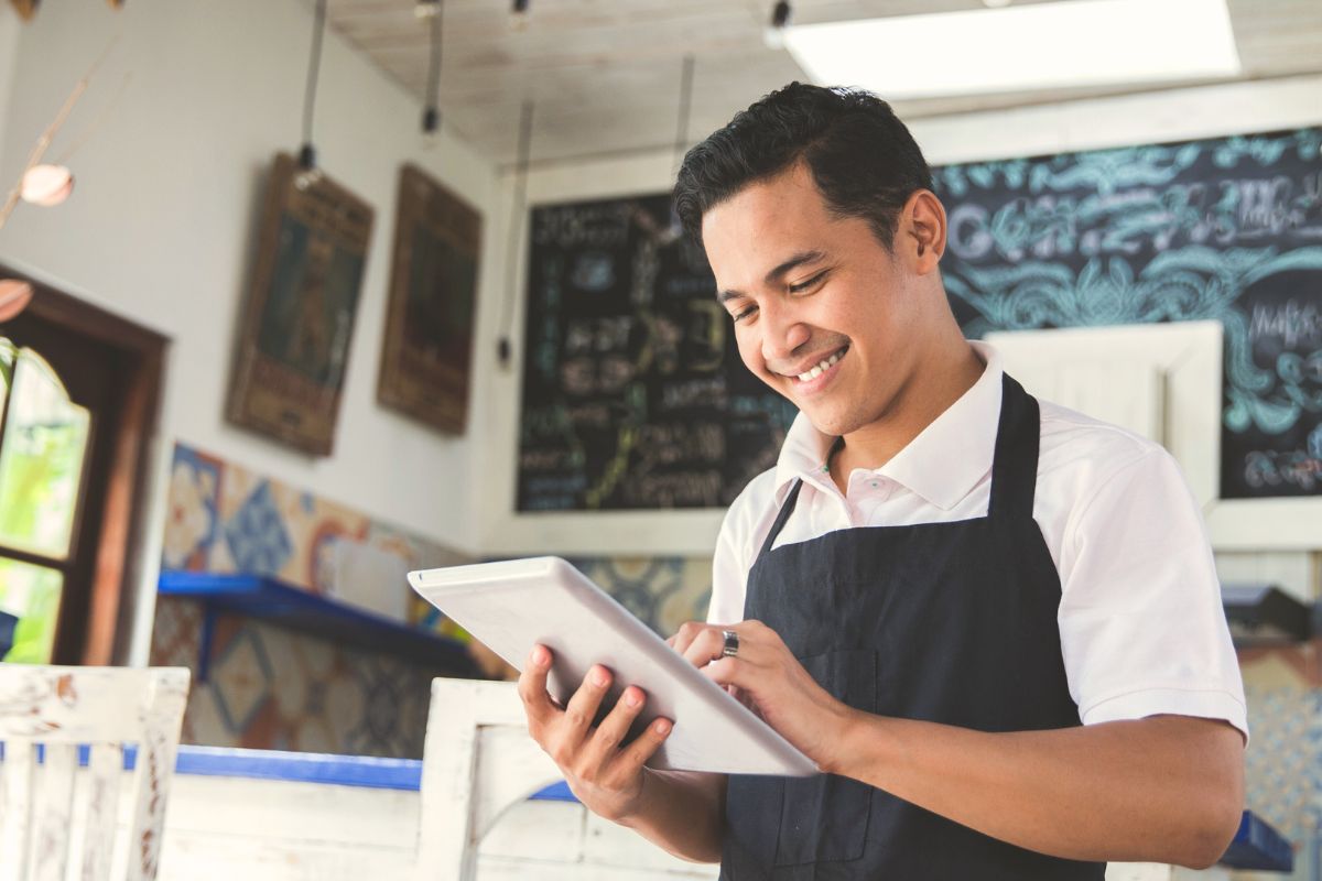 An F&B business owner on a tablet