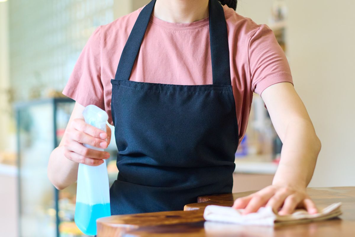 A F&B staff wiping the table