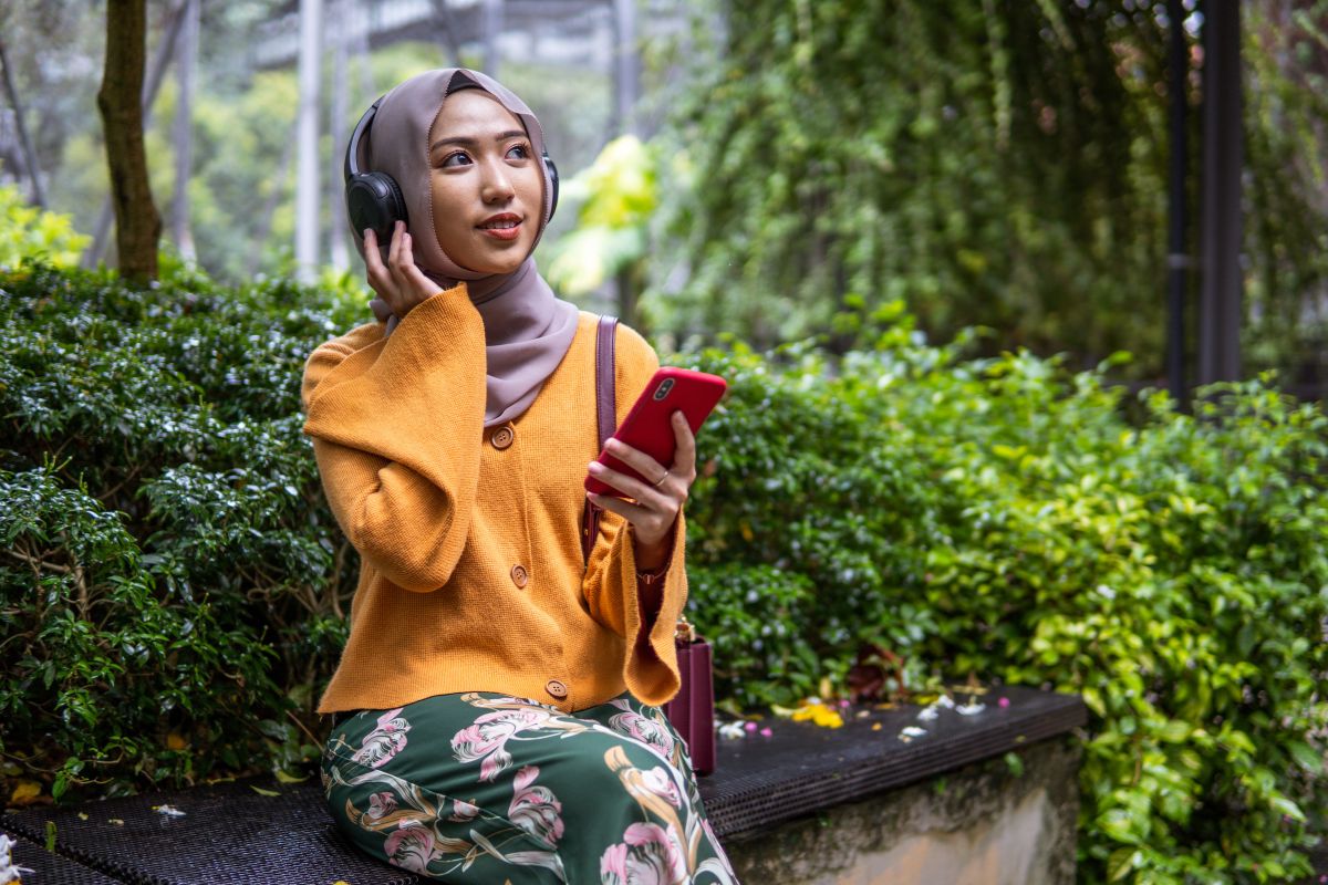 A woman listening to a podcast