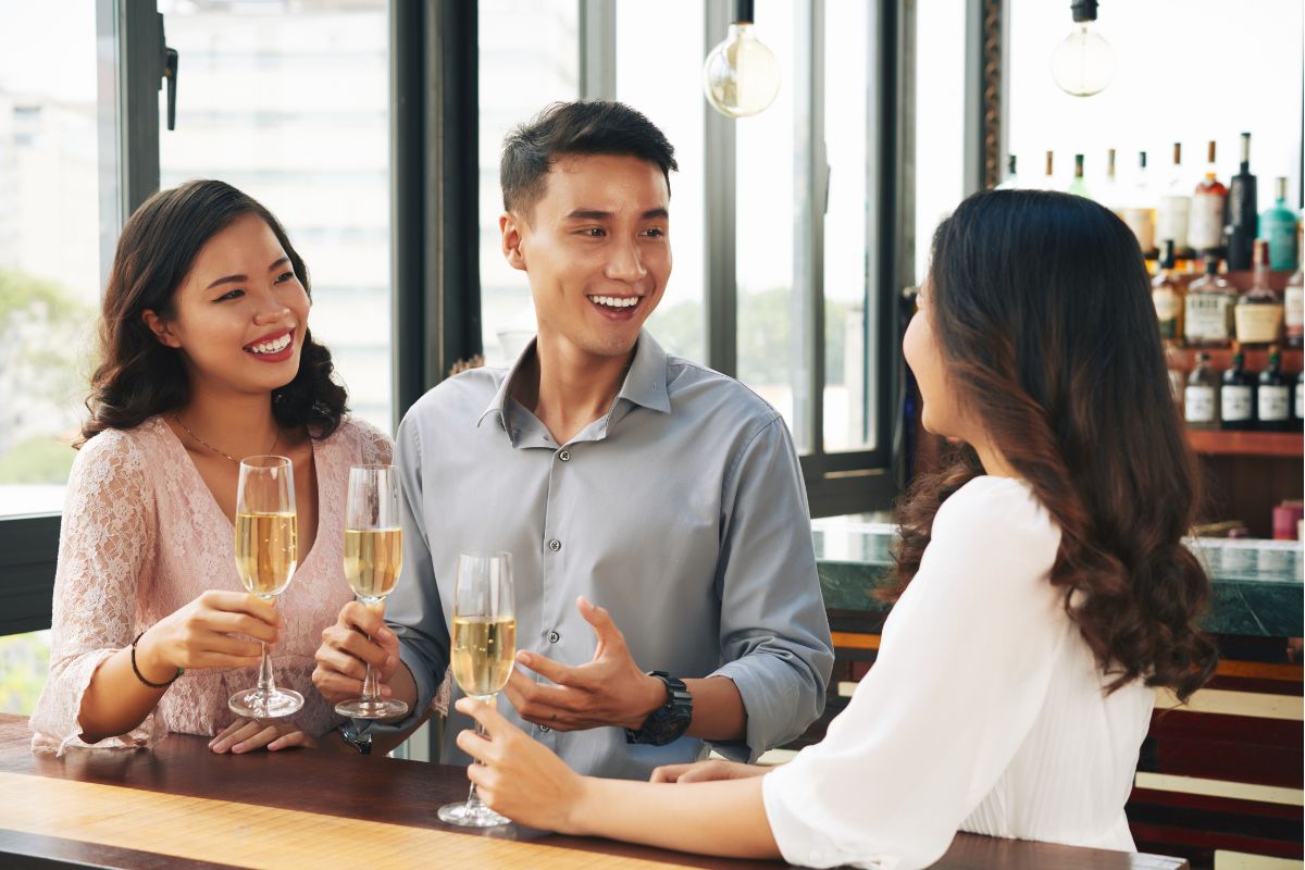 Three customers enjoying their drink at a restaurant