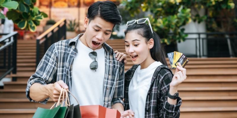 Two shoppers shocked while holding their shopping bags