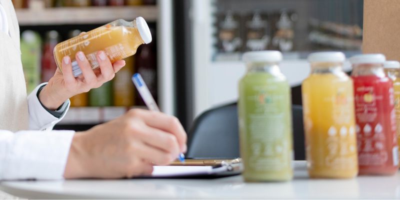 Restaurant owner writing down details of their product