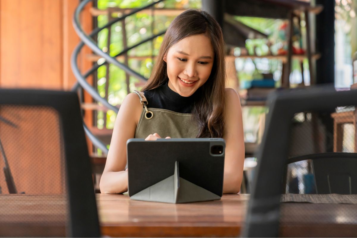 A restaurant owner on her tablet