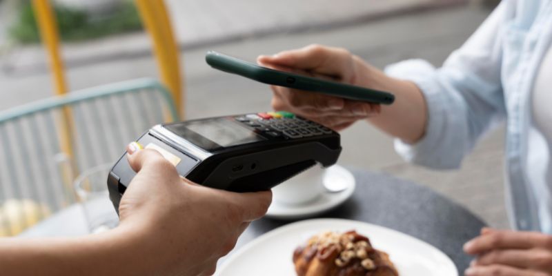 Customer doing a contactless payment using their phone