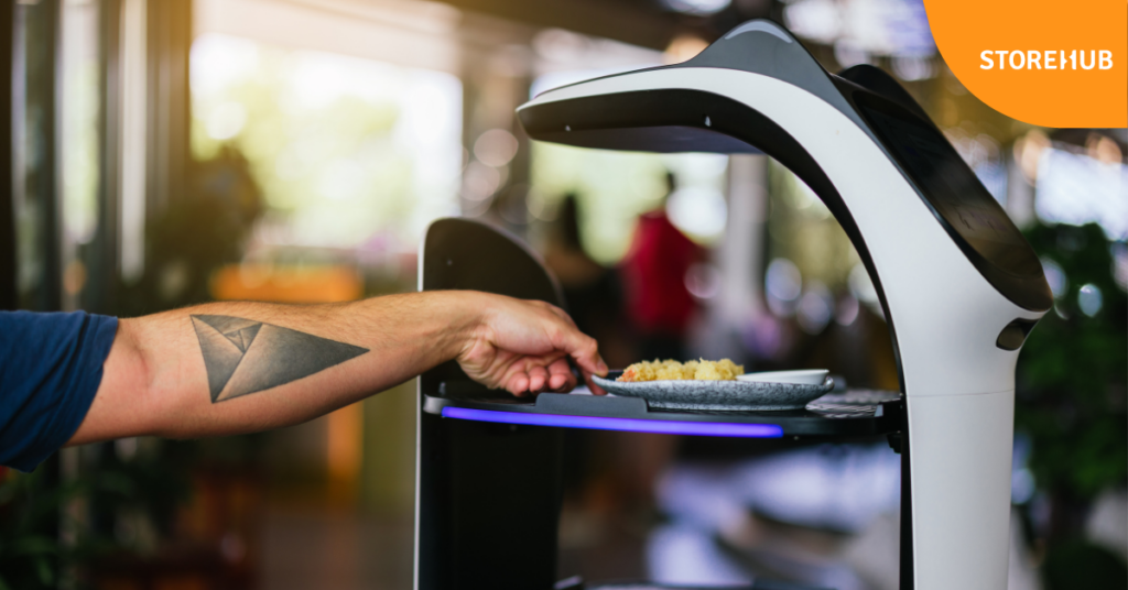 Customer unloading food from robot waiter