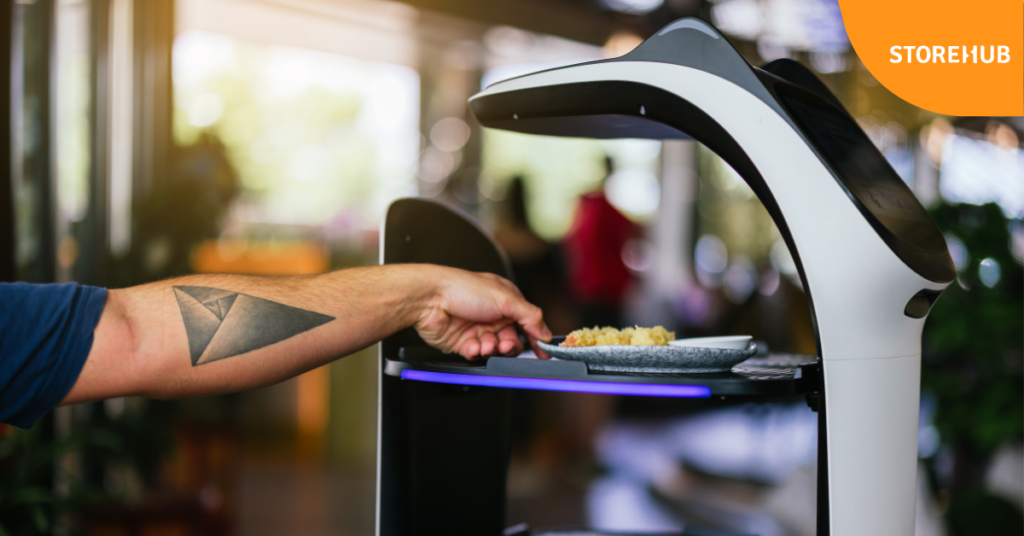 Customer unloading food from robot waiter 