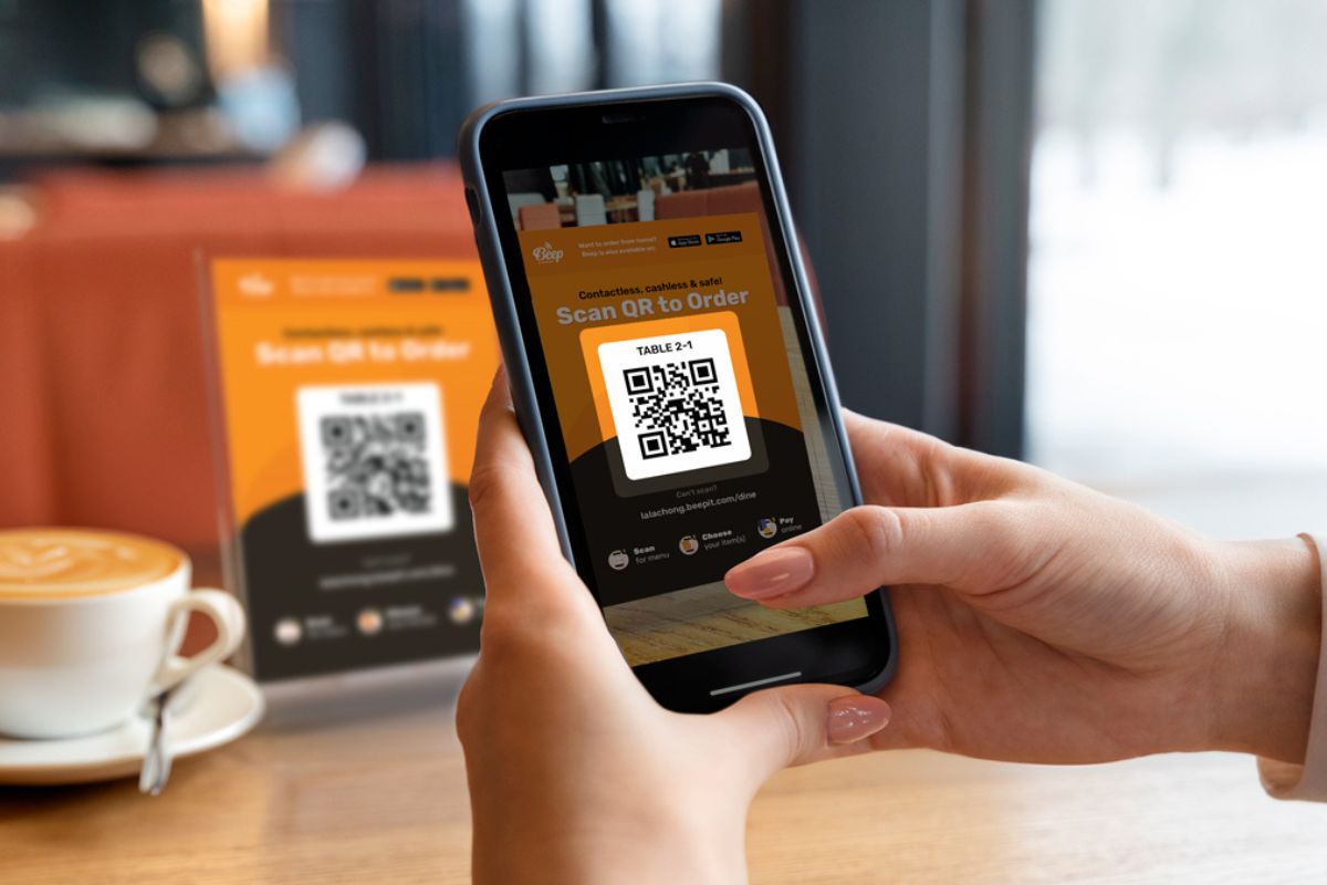 A person scanning a QR Code to order his food