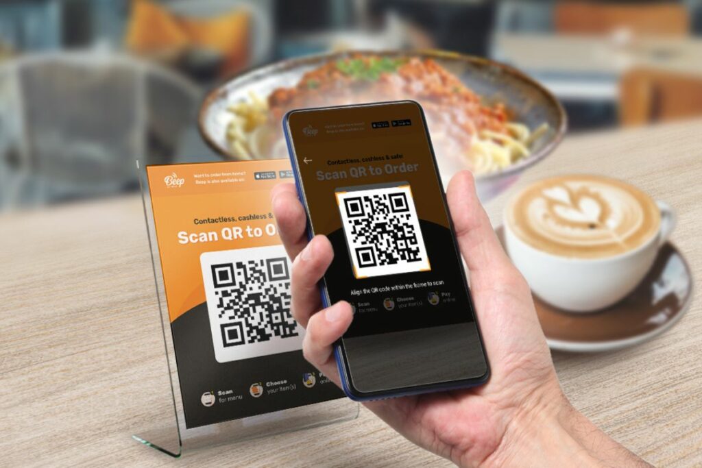 A Malaysian customer scanning a QR code to view a restaurant's menu.