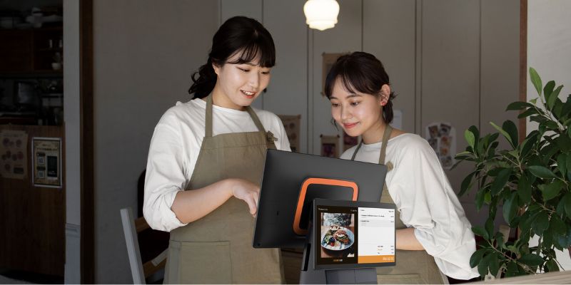 Two employees using a POS system