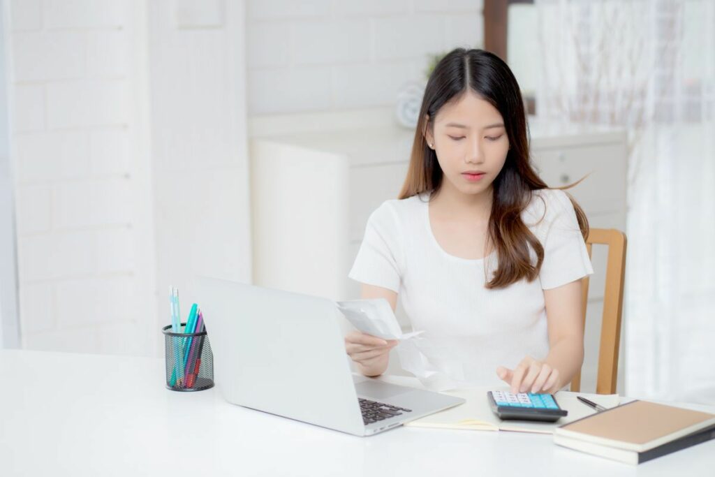 woman calculating cost of her business