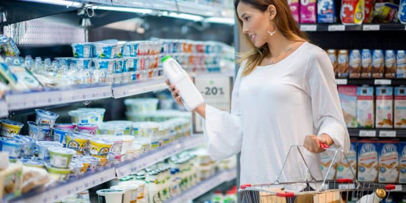 asian woman grocery looking at price