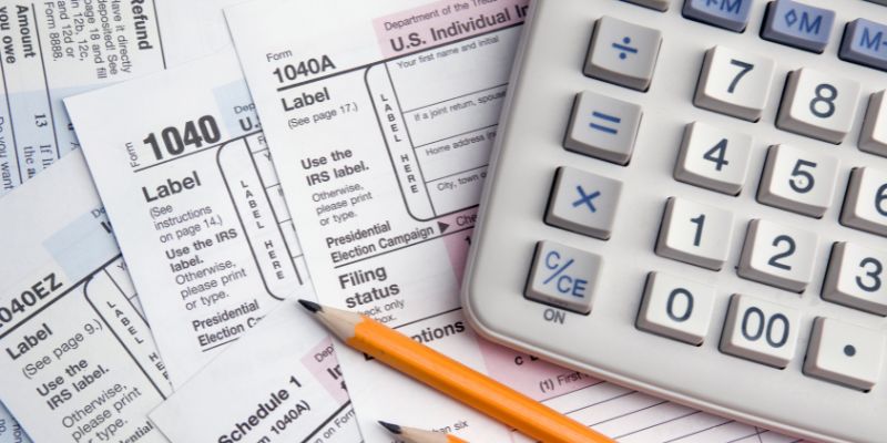 pencil, calculator, and tax forms