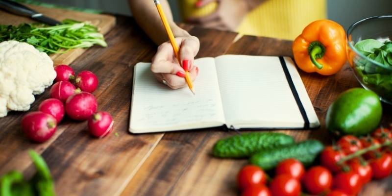 A person writing down a recipe