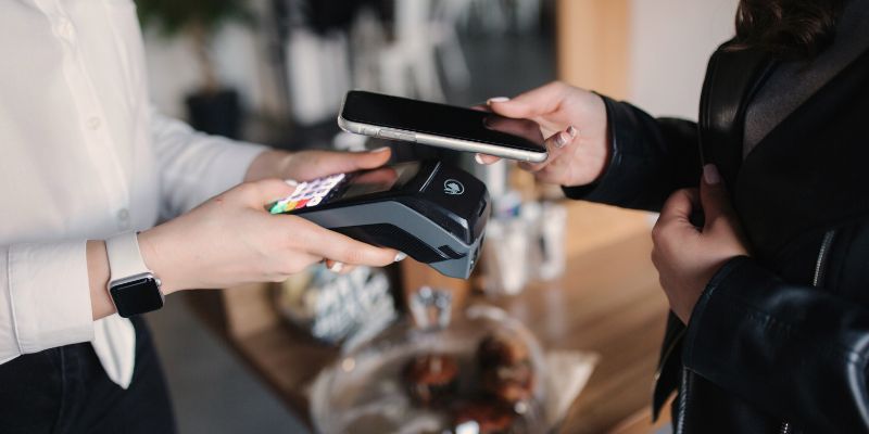 A customer paying with her phone