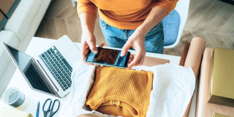 A person taking a photo of clothes