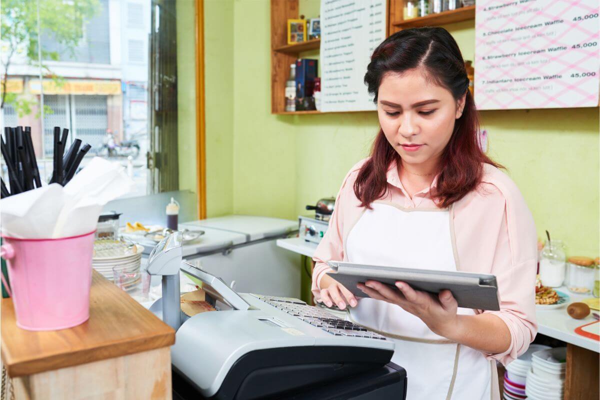 A restaurant owner calculates her business budget following Bank Negara’s OPR increase