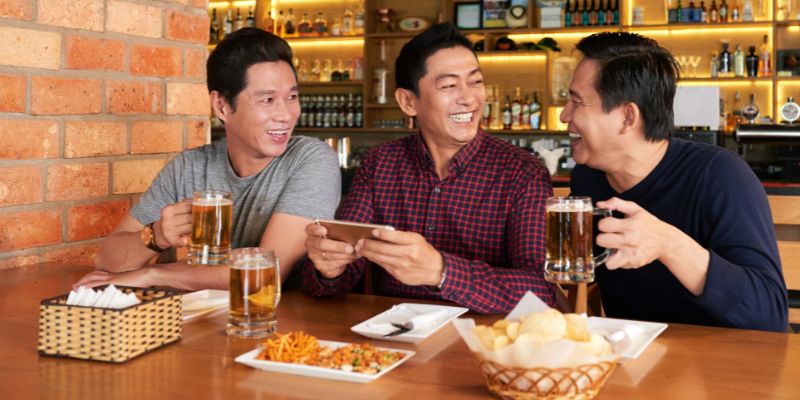 Three male friends enjoying a meal together