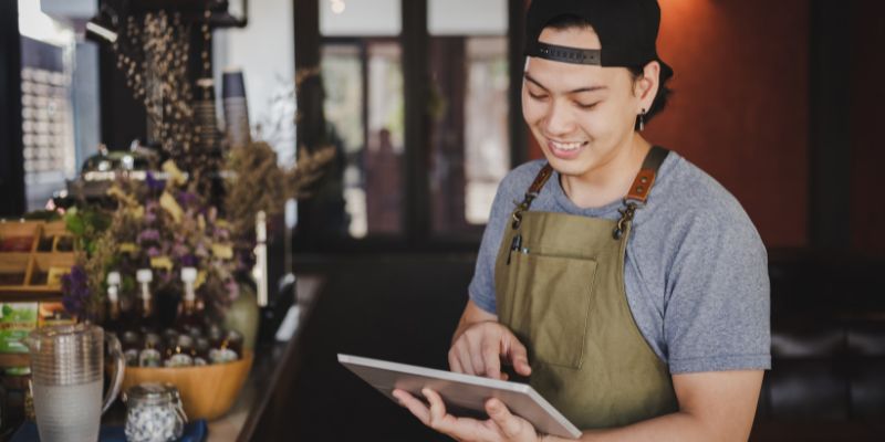 A waiter holding a tablet to make inventory orders