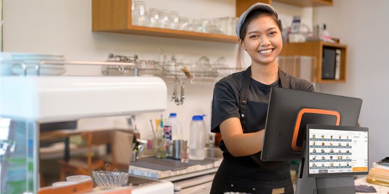 Barista using POS system to take orders