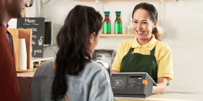 A cashier serving customers using POS