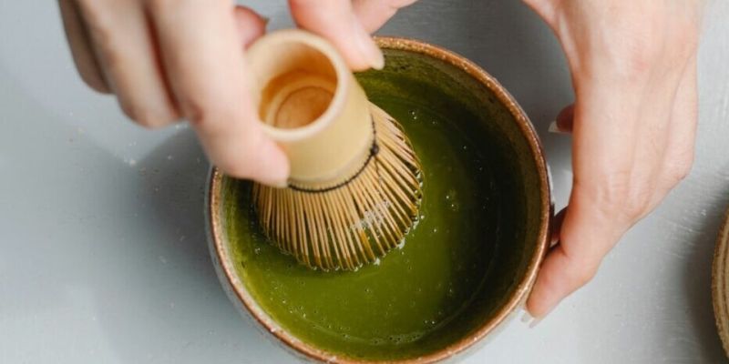 Cafe owner mixing matcha powder