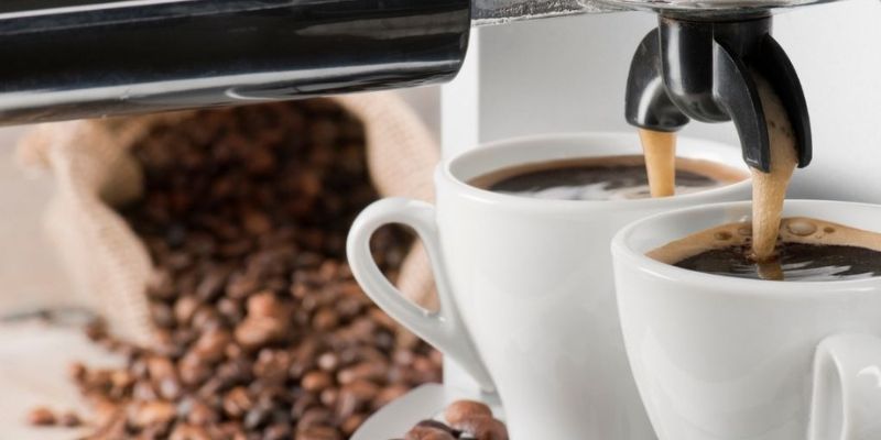 Coffee machine pouring coffee into 2 cups