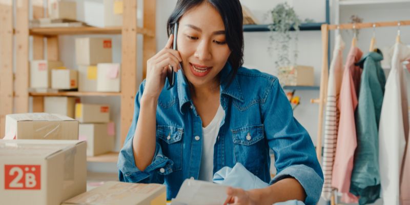 Business owner in the office calling on the phone