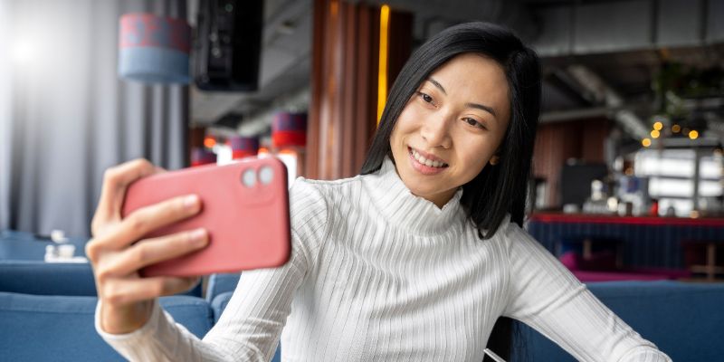 Influencer taking a selfie in a restaurant