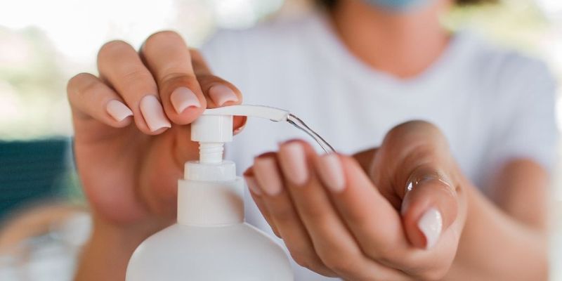 Customer squeezing a bottle of hand sanitizer