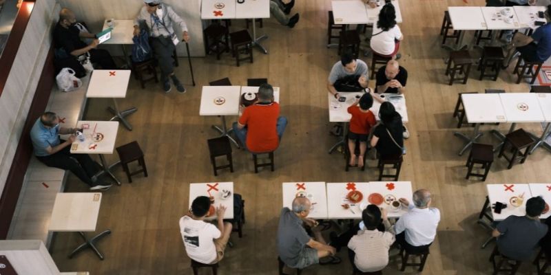 Overhead view of people in a restaurant following current SOPs