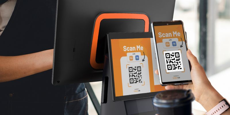 A Malaysian customer scanning the QR Code on a StoreHub point-of-sale (POS) system 