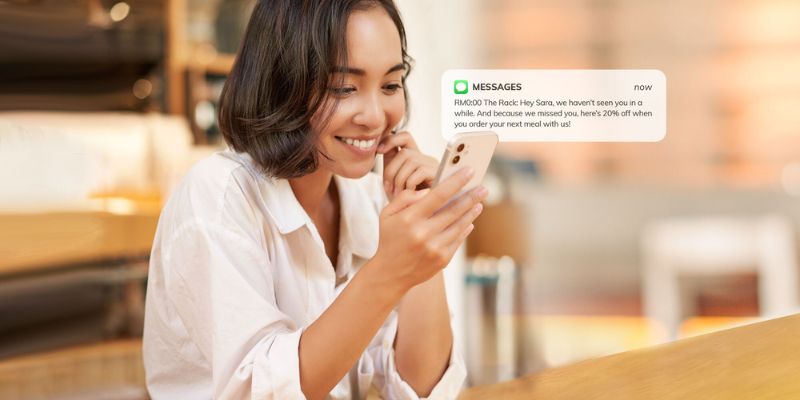 Happy customer smiling at a promotional text in a cafe.
