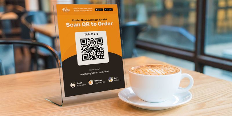 A photo of a QR Order & Pay standee for F&B businesses