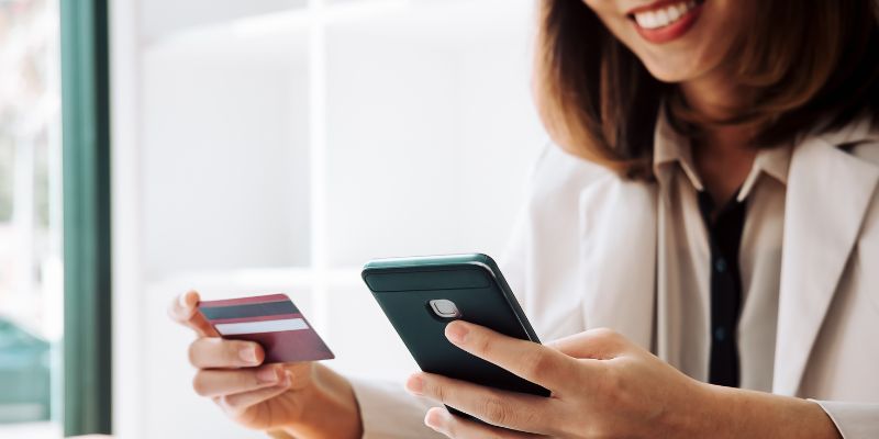 A Malaysian paying for her restaurant order through her phone