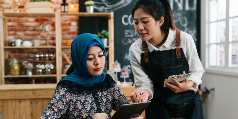 A waitress taking an order in an F&B business