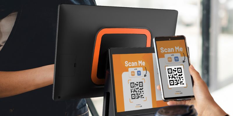 A Malaysian customer scanning a QR Code on a StoreHub POS to claim his points and cashback