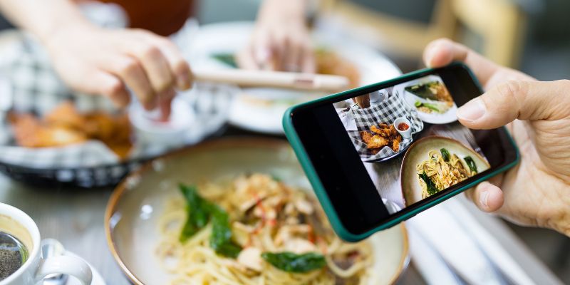 A Malaysian customer taking photos of his food