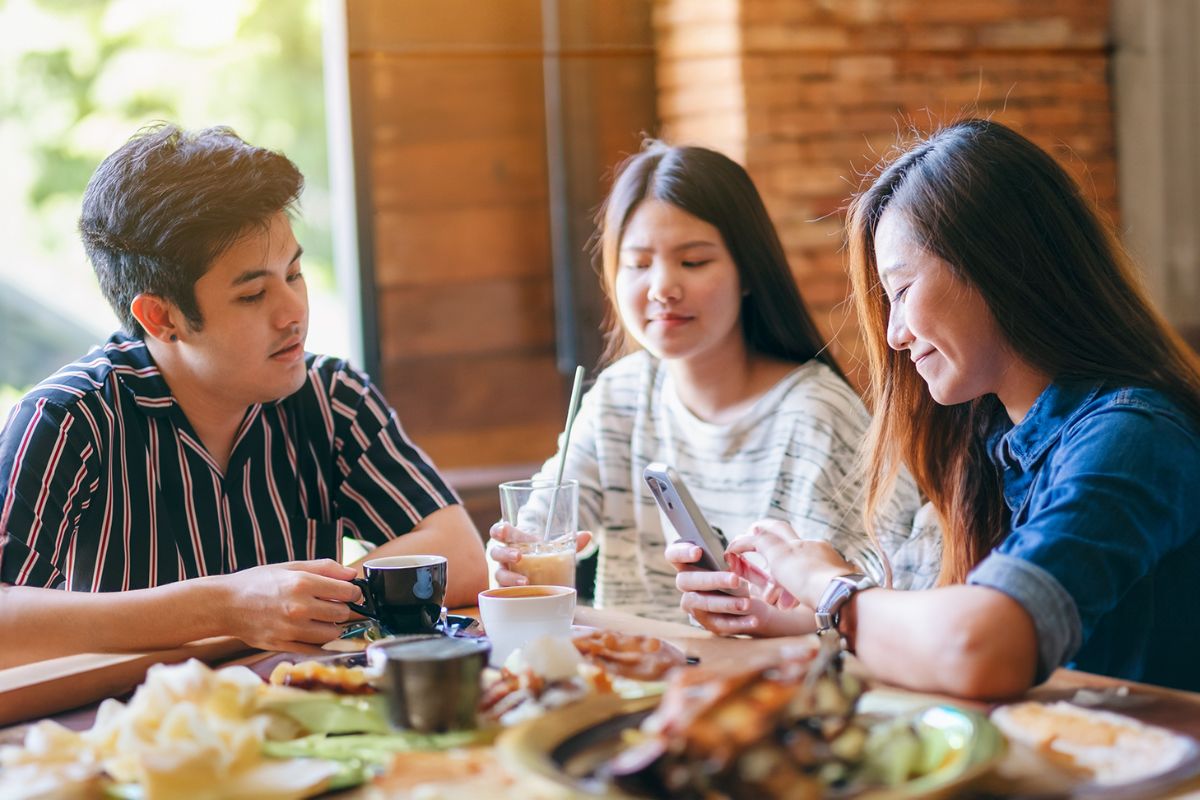 A group of friends dining at a Malaysian restaurant