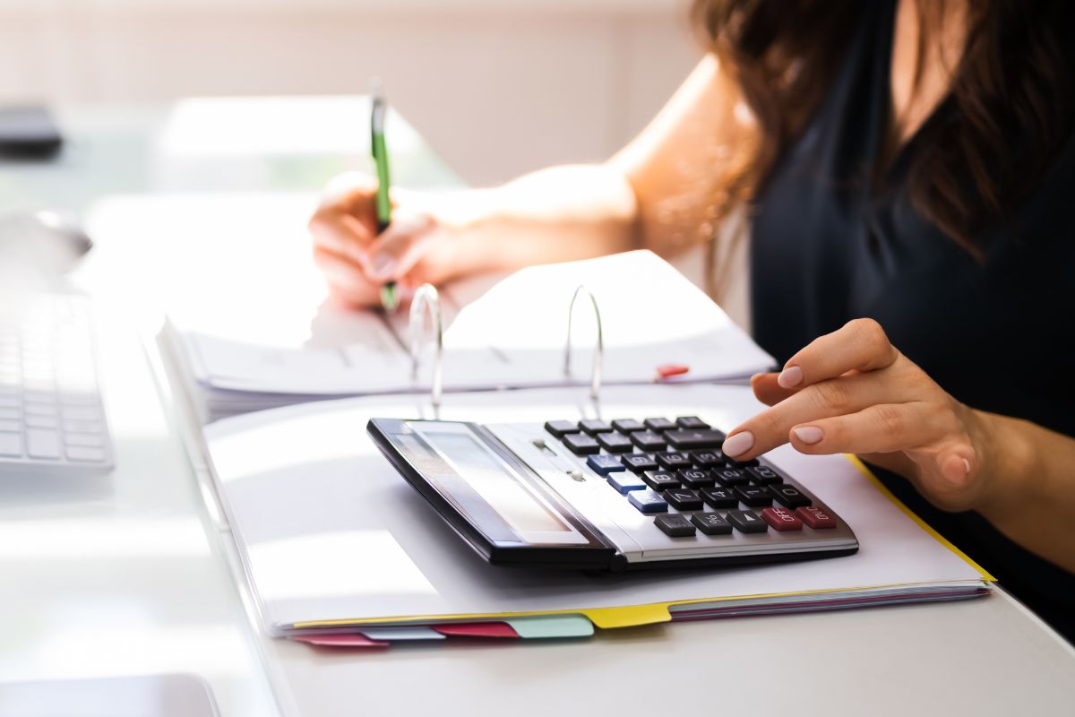 Woman using a calculator for budgeting