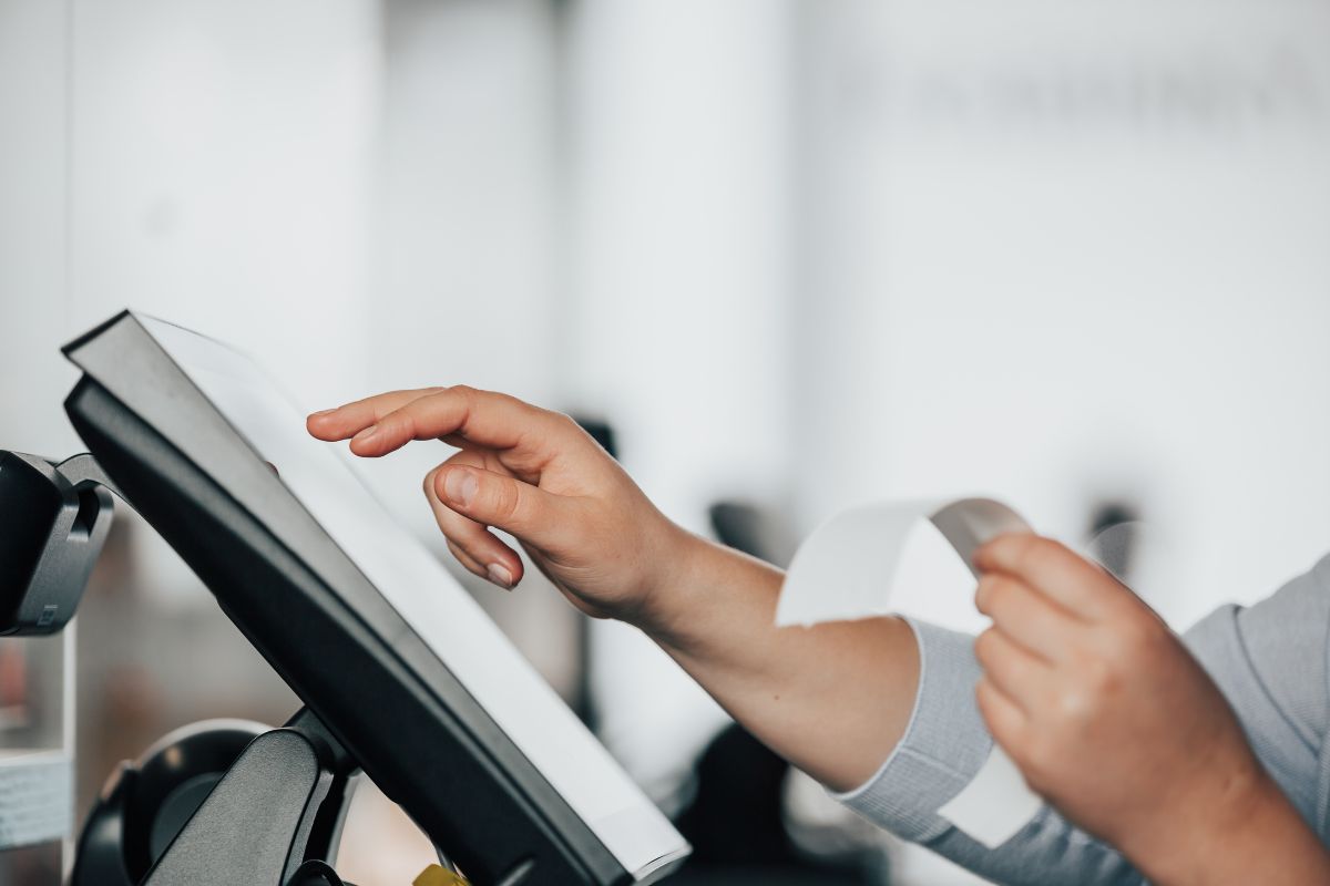 An F&B staff member in Penang processing an order using a POS system.