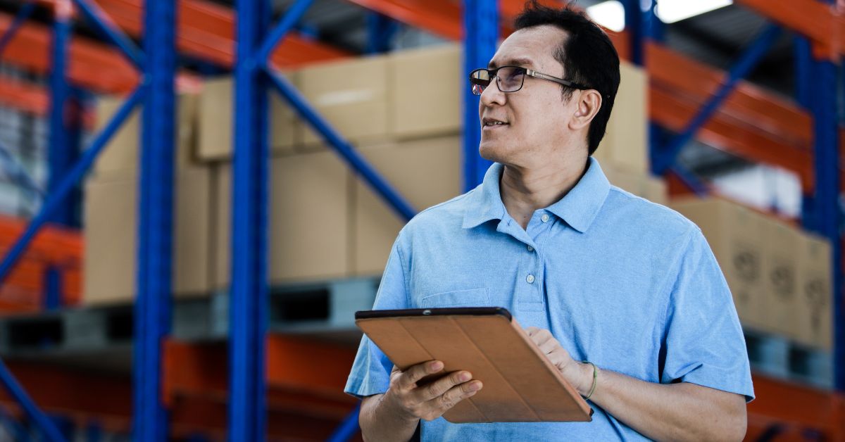 Malaysian business owner checking inventory at warehouse