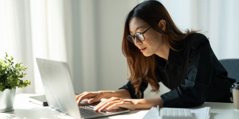 Malaysian SME business owner working on her laptop