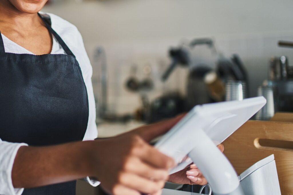 A Malaysian F&B staff with a POS system