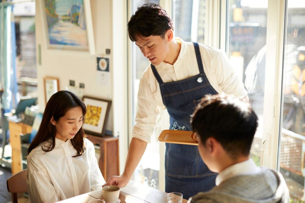 A Malaysian F&B staff serving customers