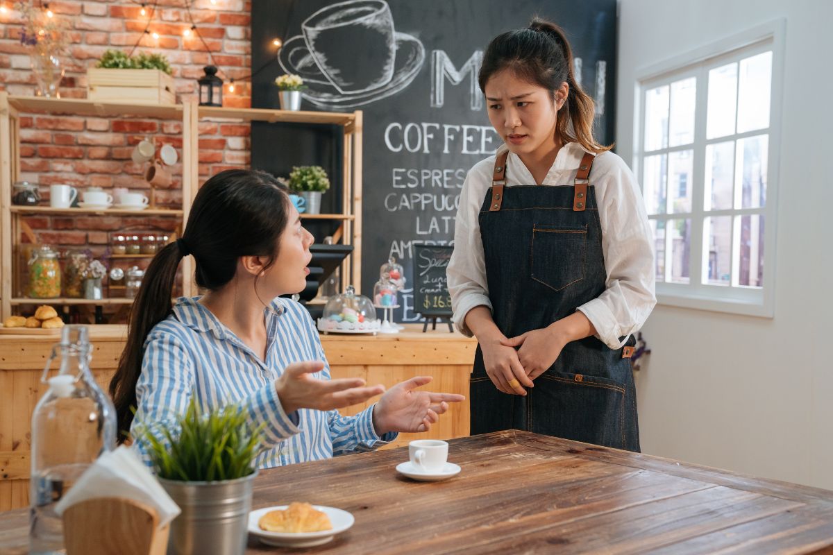 An angry and disappointed customer talking to a F&B employee