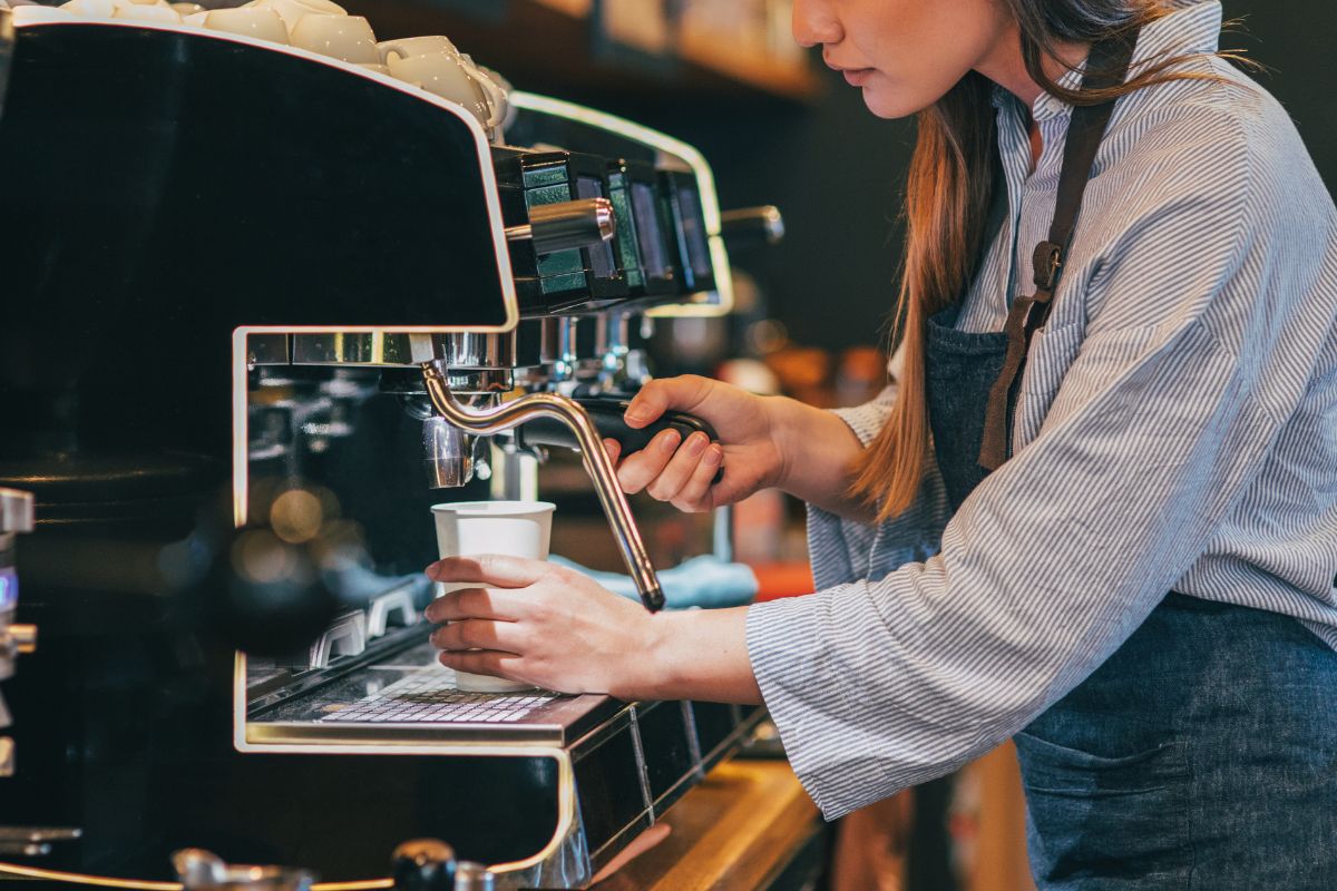 A Filipino business owner making coffee