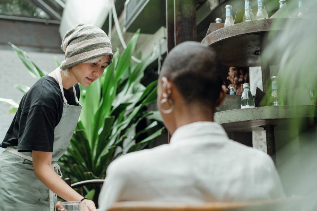 A restaurant staff serving food to the customer