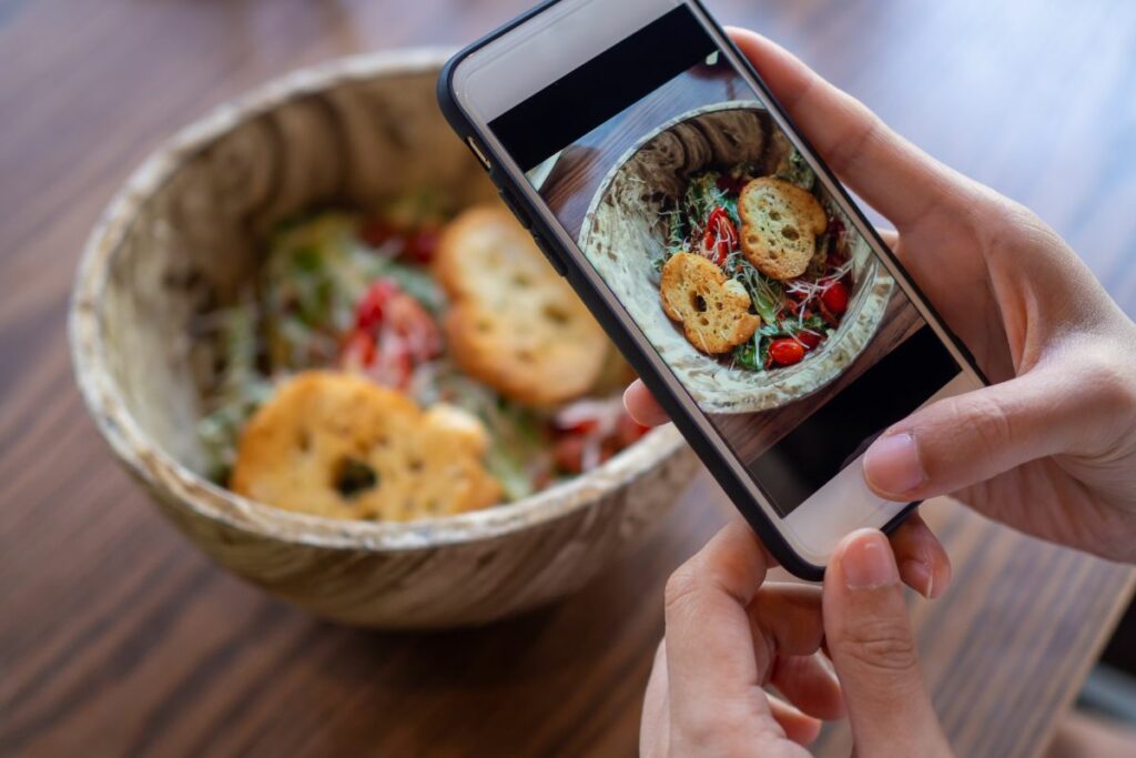A person taking a photo of food