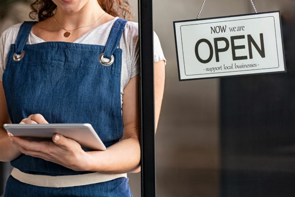 A F&B business owner at the front of her restaurant