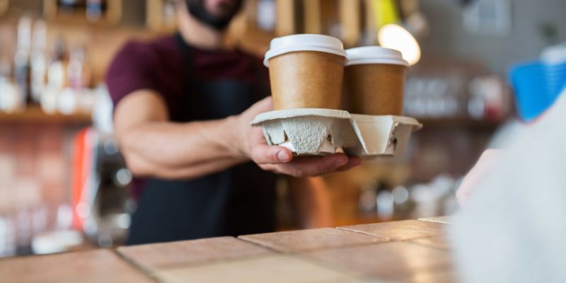 A Filipino waiter serving coffee to the customer
